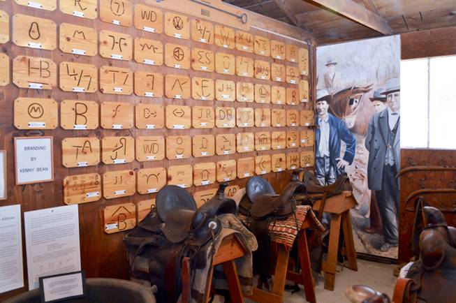 A wall of cattle brands and tack is shown in the Lyon County Museum, Wednesday, Oct. 23, 2013. The brands were all registered in the area.